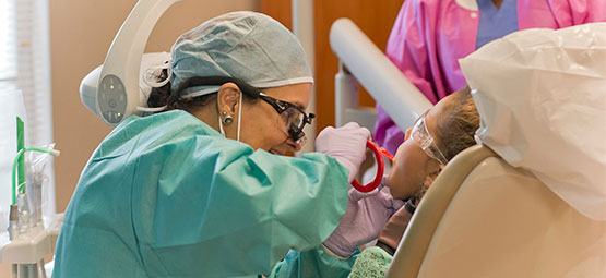 Dental student working with patient