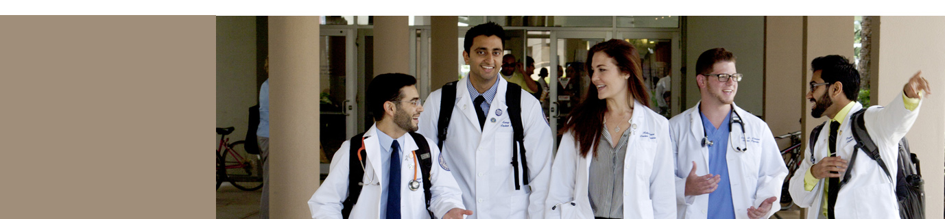 : Student doctors walking down hallway and laughing