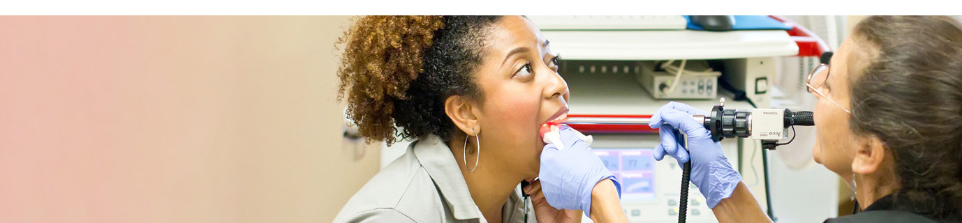 Student doctor checking a patient’s jaw