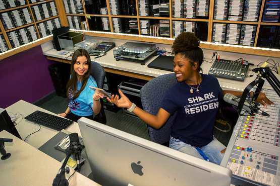 students working in the radio station room